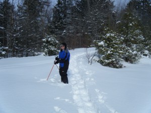 Marie snowshoeing in deep snow.